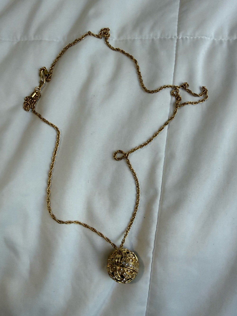 Gold Colored Long Necklace with a Rhinestone Ball